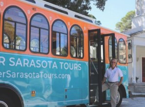 A tour bus with "Sarasota Tours" written on the side.