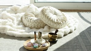 A room with a large window overlooking the sea, a white fluffy rug, a wooden tray with crystals, and a small altar with a candle and a bowl. - Oceans Views Zen Retreat | 6 Min Walk to Beach | Dolphin Spotting | Pet OK (Malibu)