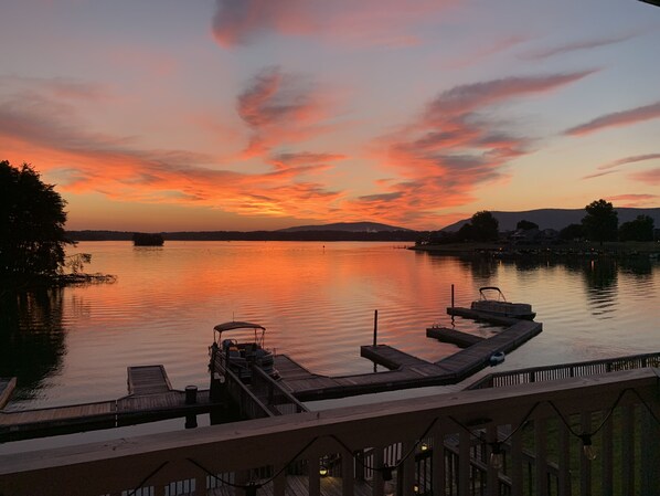 A lakeside view with a dock and a wooden pier extending into the water. - Charming Lakefront Condo at Bernard's Landing, only steps from the shore! (Moneta)