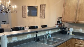 A modern kitchen with granite countertops, wooden cabinets, a dishwasher, and a built-in oven. - Only 2 miles from shopping, banking, food, entertainment,15 to downtown Atlanta (Lithonia)