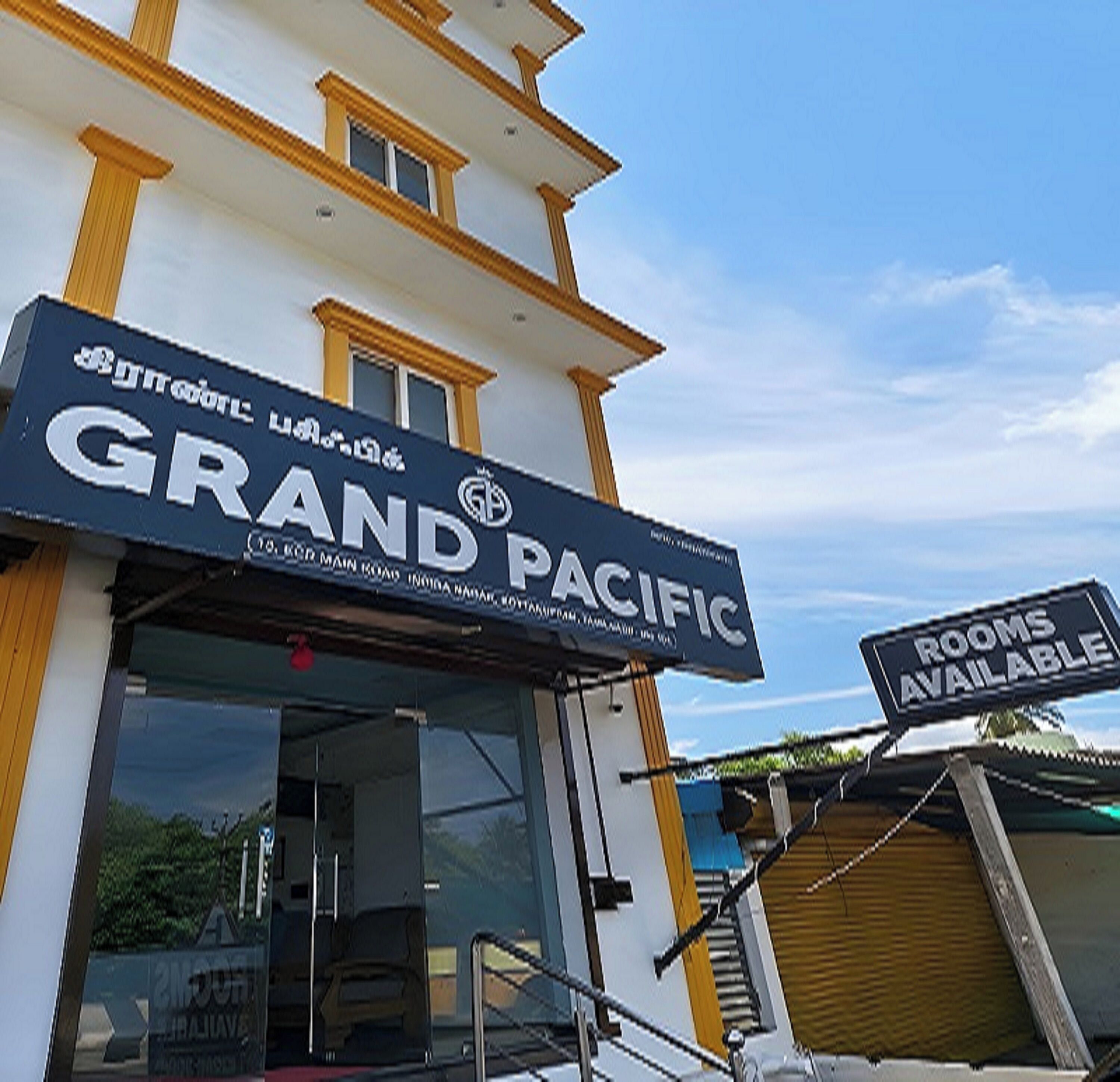 A hotel named GRAND PACIFIC with a sign indicating rooms are available.