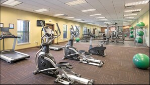 A gym with treadmills, elliptical machines, and exercise balls. - Great Smokey Mountains Resort - Pigeon Forts Condo  (Pigeon Forge)