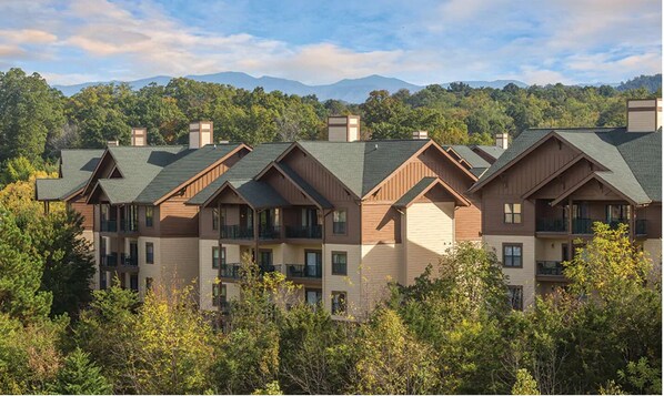 A multi-story hotel with a consistent architectural style, featuring dormer windows and balconies.