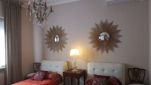 A hotel room with two single beds, a chandelier, wall mirrors, a lamp, and a chair. - Room in Apartment - Villa Piera Holiday Home in Cremona Apartment With Independent Entrance (Cremona)