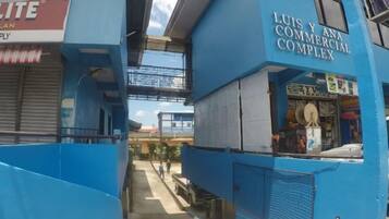 A commercial building with a sign for 'LUIS Y ANA COMMERCIAL COMPLEX' and a visible storefront.