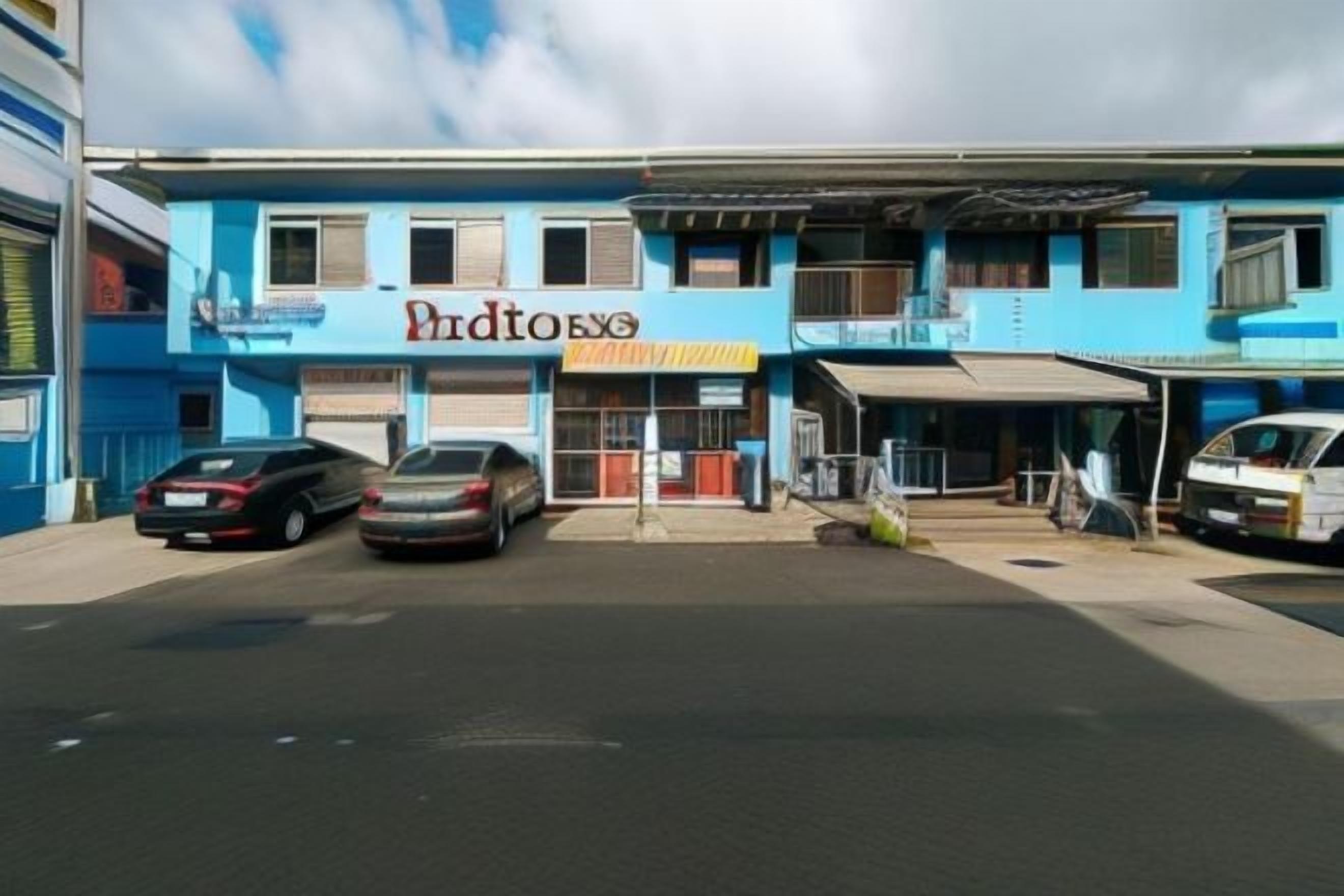 Een gebouw met twee verdiepingen met een etalage met de tekst 'Pinto's'. Er staan twee auto's ervoor geparkeerd.