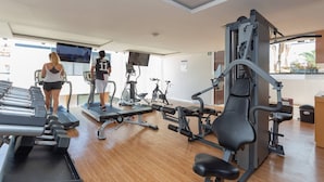 A gym with treadmills, weight machines, and exercise bikes. - Cozy Studio In Playa Del Carmen Downtown - Few Steps From the Beach!!! (Playa del Carmen)