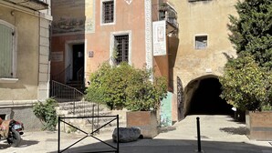 A building with a traditional facade, a small entrance, and a gate.