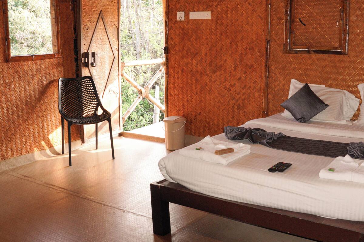 A room with a bed, a chair, and a window.