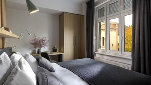 A modern bedroom with a bed, desk, and wardrobe. - Colors of Music (Zagreb)