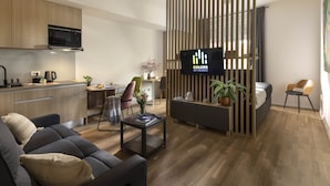 A modern living room with a sofa, coffee table, and a TV displaying 'COLORS OF MUSIC'. - Colors of Music (Zagreb)