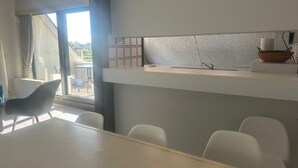 A modern kitchen with a countertop, a sink, and a basket on the counter.