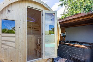 A wooden sauna with a glass door, a hot tub, and a view of the surrounding area. - Design studio, jacuzzi, private terrace, air conditioning (Furdenheim)