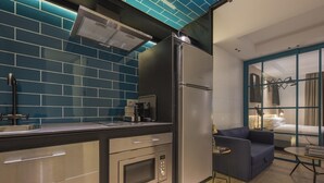 A modern kitchen with a built-in oven, a coffee machine, and a refrigerator. - CHAYOFA SUITES - STUDIO (Santa Cruz de Tenerife)