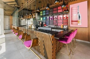 Enjoy a stylish drink at the bar, where a variety of bottles and glasses are always available.