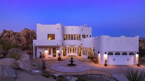 A modern building with a central courtyard, multiple entry points, and a garage. - Casa Blanca by Fieldtrip - Boulder Estate with Hot Tub, Soaking Pool & Outdoor Shower (Yucca Valley)