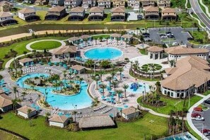 A resort with a central pool, multiple guest villas, and a parking area. - 8 Bedroom Movie Theater In Home Champions Gate! 8 Villa by RedAwning (Davenport)