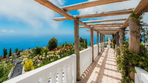 A wooden pergola with a tiled pathway leading to a view of the sea. - Blue Sea Tower, Luxury Villa, Private Heated Pool and Gardens. Superb Ocean view (Fajã da Ovelha)