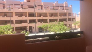 A multi-story building with balconies and a street view. - Condado De Alhama golf resort (Alhama de Murcia)