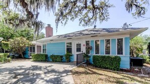A single-story house with a gabled roof, a front porch, and a small attached garage.