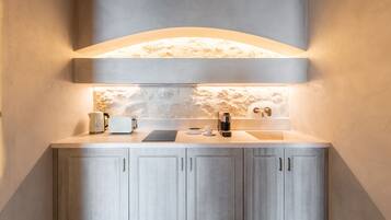 A modern kitchen with a built-in island, a coffee machine, and a sink.