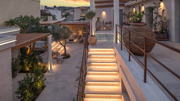A rooftop terrace with a staircase, potted plants, and outdoor seating. - Inotropes Boutique Suites - Adults Only (Archanes-Asterousia)