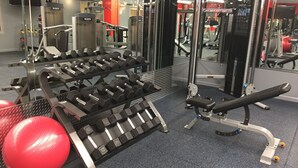 A gym with weightlifting equipment, exercise balls, and mirrors. - Mana Kai 404, Beautifully Renovated, Unbelievable Ocean View (Kihei)