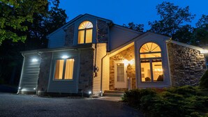 A two-story house with a stone facade and a gabled roof. - Hot Tub, Pool, Game Room and more fun for the whole family (East Stroudsburg)