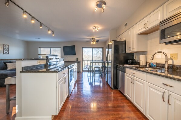 Enjoy cooking in this well-lit kitchen with a large island and sink.