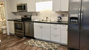 A modern kitchen with white cabinets, stainless steel appliances, and a coffee maker. - ❤️ 🏙 The View-Stylish Interior- Min to downtwn 🌃 ❤️ (Cincinnati)