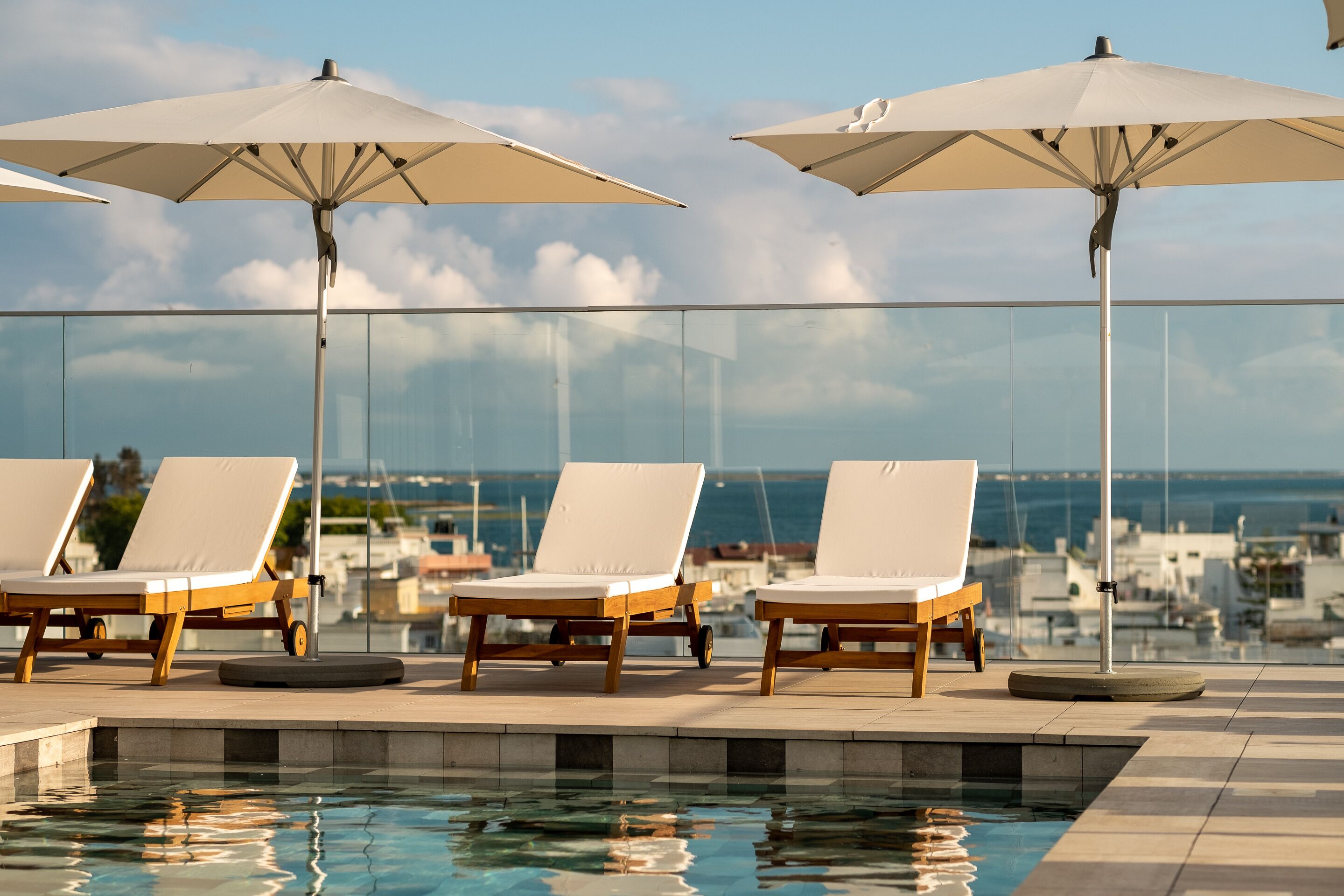 outdoor pool, open 9:00 am to 8:00 pm, pool umbrellas, pool loungers