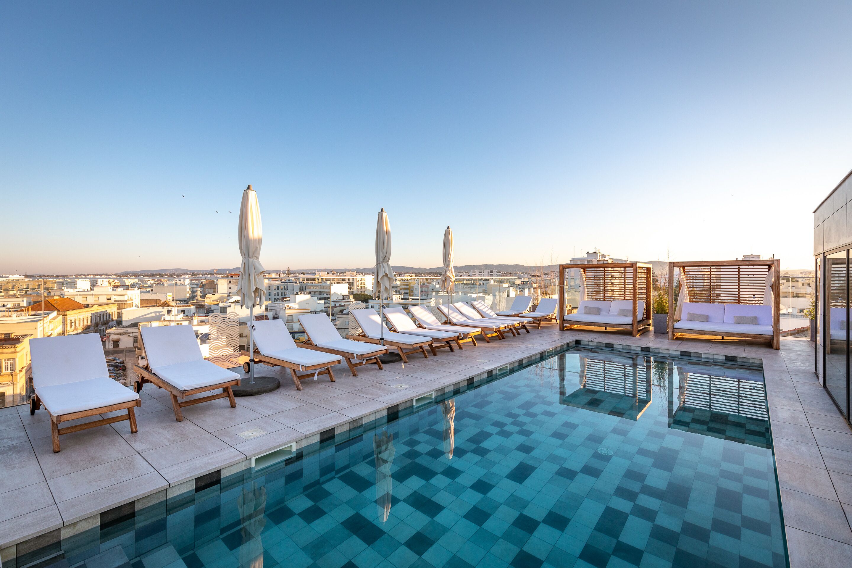 outdoor pool, open 9:00 am to 8:00 pm, pool umbrellas, pool loungers