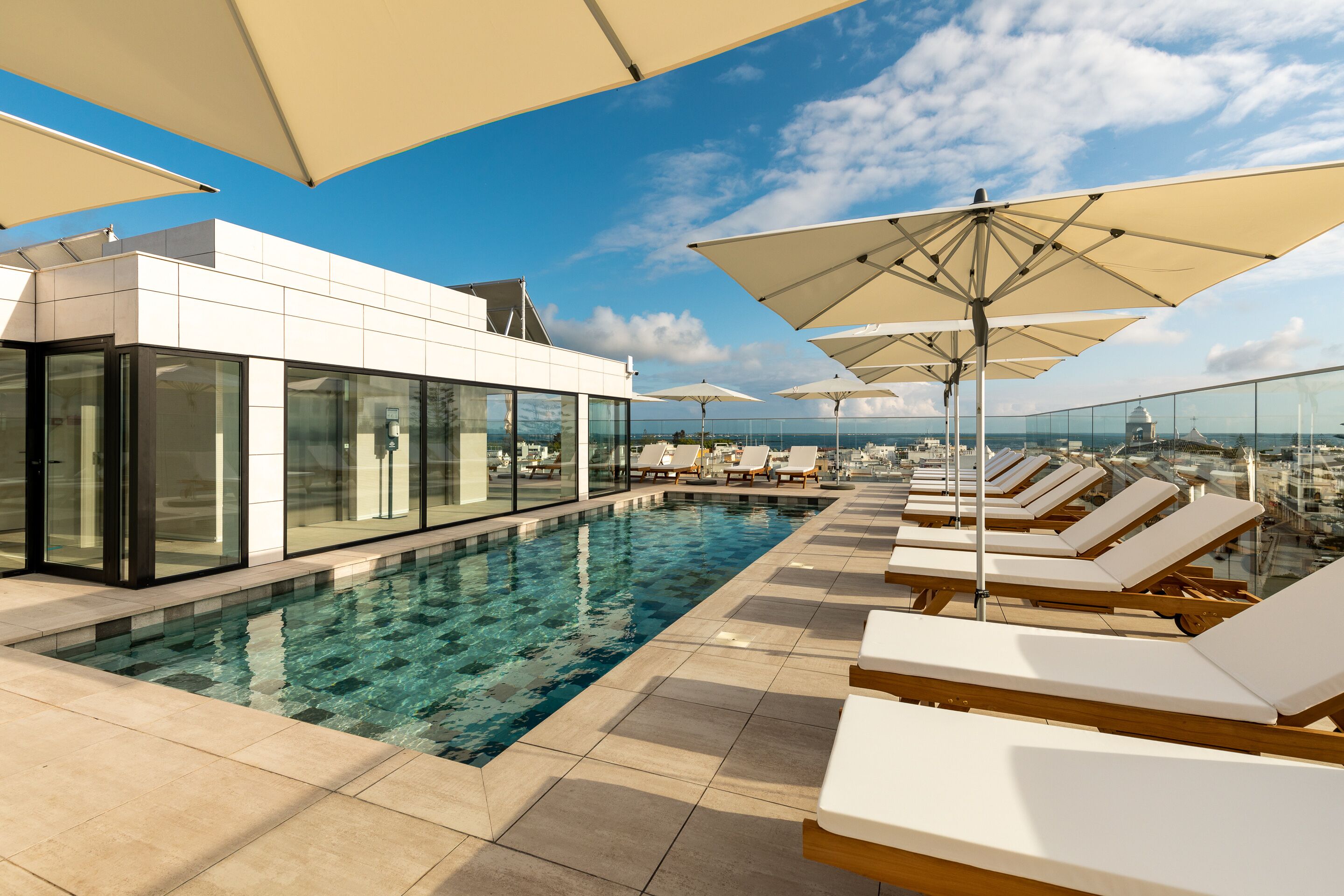 outdoor pool, open 9:00 am to 8:00 pm, pool umbrellas, pool loungers