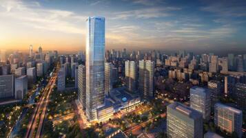 A high-rise building with a modern glass facade, surrounded by a dense urban skyline with various other high-rise buildings.
