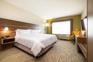 A hotel room with a large bed, bedside tables, a desk, a chair, a flat-screen TV, and a window with blinds. - Holiday Inn Express & Suites San Jose Silicon Valley by IHG (San Jose)