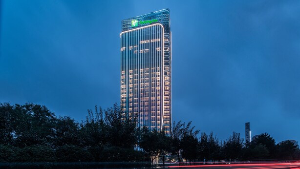 A tall hotel building with a prominent sign at the top. - Holiday Inn Xi an Chanba by IHG (Xi'an)
