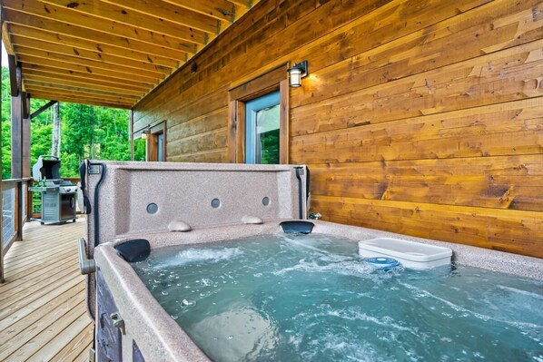 A hot tub with a wooden deck and a wooden cabin in the background. - NEWLY BUILT Amazing View Chalet•Perfect Location (Gatlinburg)