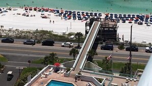 A hotel with a pool, beach view, and a parking area. - PENTHOUSE -16TH FLOOR with FREE BEACH SERVICE.  AMAZING VIEW!! (Miramar Beach)