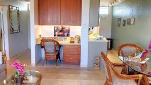 A compact living space with a kitchenette, dining area, and seating. - AMAZING HOTEL ZONED BEACH FRONT CONDO ON SUGAR BEACH.  RESERVE WITH CONFIDENCE! (Kihei)
