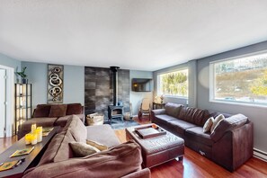 Relax in this inviting living room with a fireplace, flat-screen TV, and comfortable seating areas.