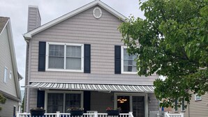 A two-story house with a front porch, a small garden, and a driveway. - 2 Blocks From Beach (Manasquan)