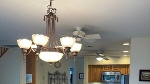 A spacious kitchen with wooden cabinets, a dining table, and a ceiling fan. - 2 Blocks From Beach (Manasquan)