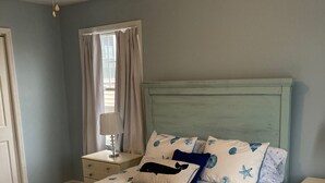 A bedroom with a bed, nightstands, a lamp, and a ceiling fan. - 2 Blocks From Beach (Manasquan)