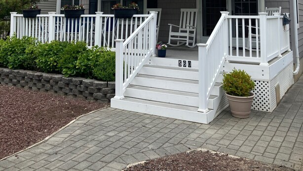 A two-story house with a front porch, white railings, and a mailbox. - 2 Blocks From Beach (Manasquan)