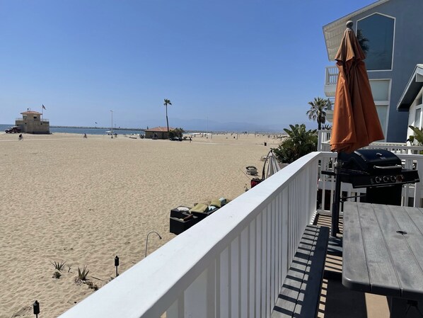A beach view from a balcony with a barbecue grill, a white railing, and a view of the beach and ocean. - BEACHFRONT PROPERTY! BEST L.A. LOCATION! (Los Angeles)