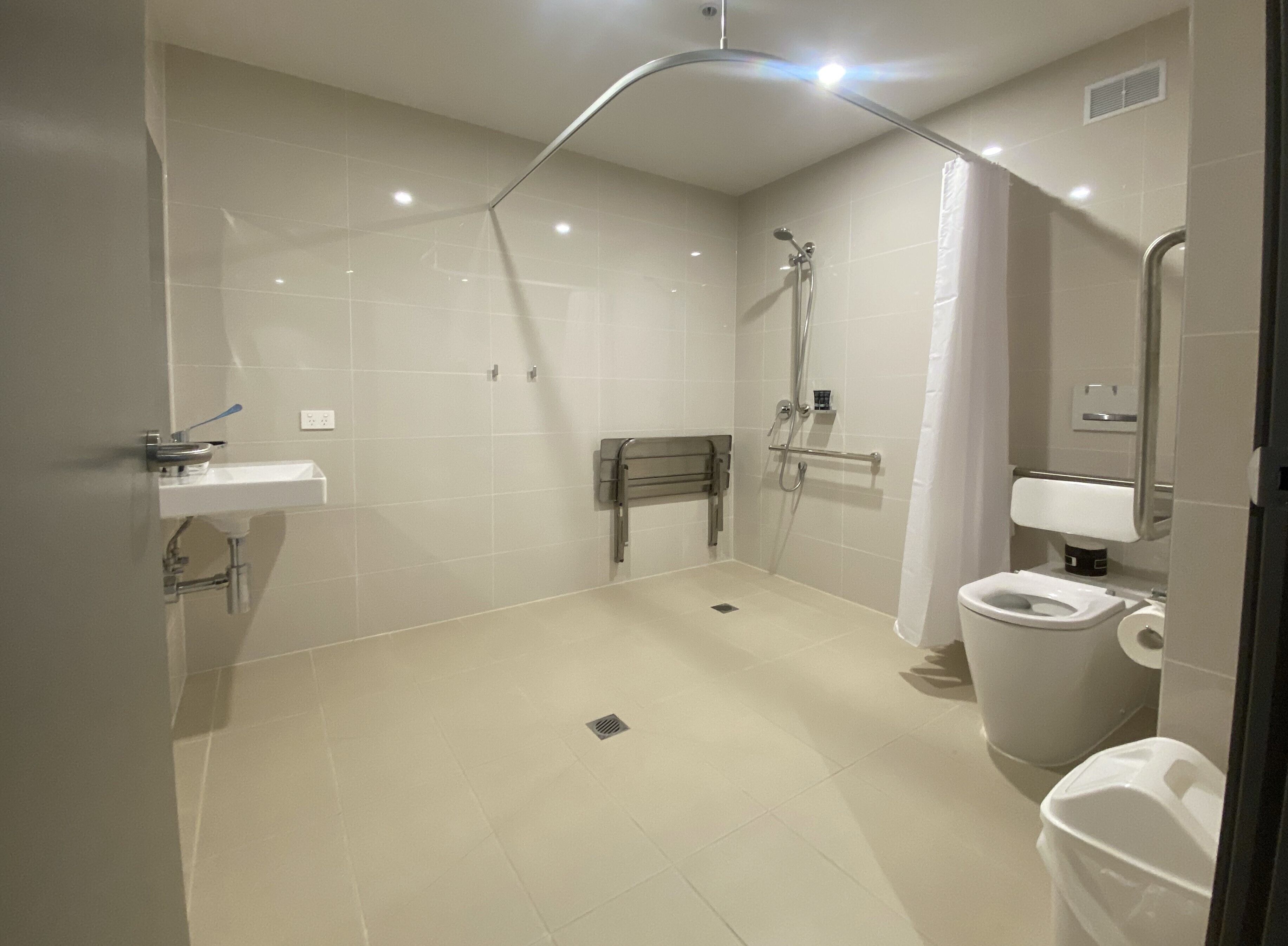 Un bagno moderno con doccia, WC e lavandino.