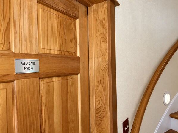 A wooden door with a sign reading 'MT ADAIR ROOM'.