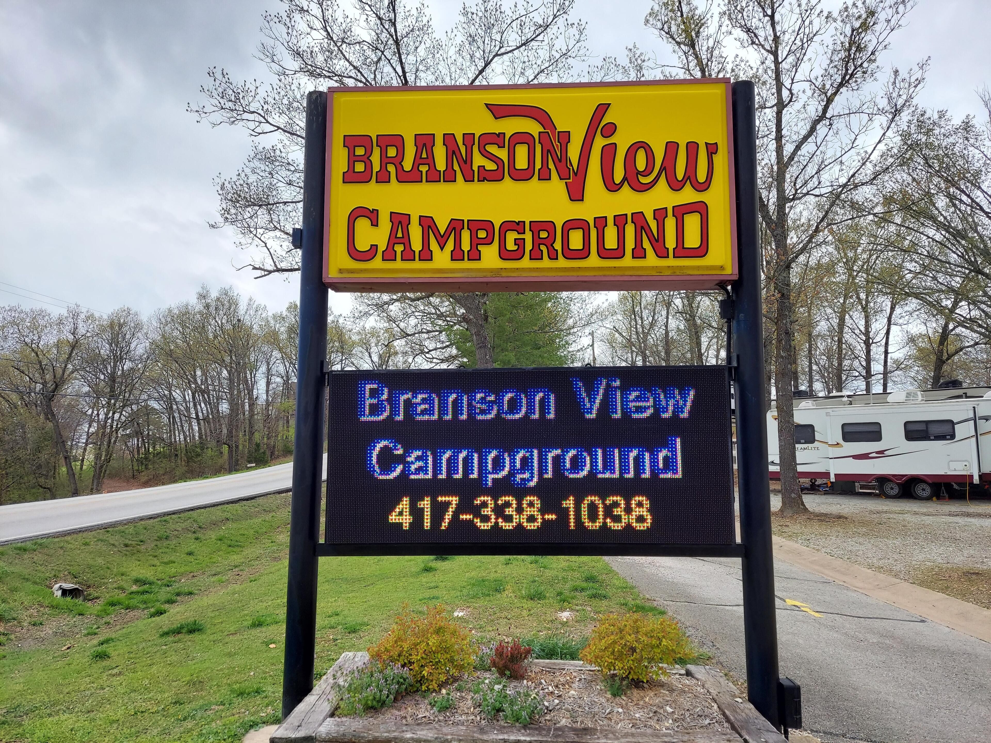 A campground sign with the name 'Branson View Campground' and a phone number.