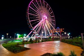 A Ferris wheel with a sign that reads "BRANSON PERRIS WHEEL" at night. - Spruce Valley (Branson)