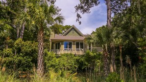 A house surrounded by dense tropical vegetation. - Gorgeous Natural Light, Vaulted Ceilings & Fairway Views.  Back Deck & Screened Porch. (Kiawah Island)
